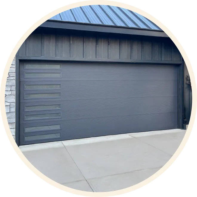 Modern dark gray garage door with horizontal panels and vertical glass inserts